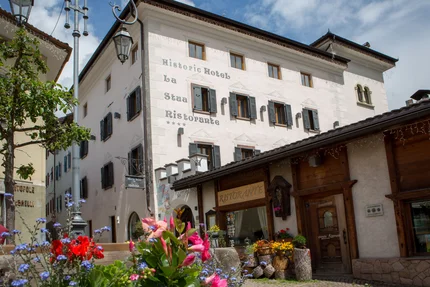 Hotel La Stüa © Hotel La Stüa Historisch hotel en restaurant La Stua met bloemen op de voorgrond