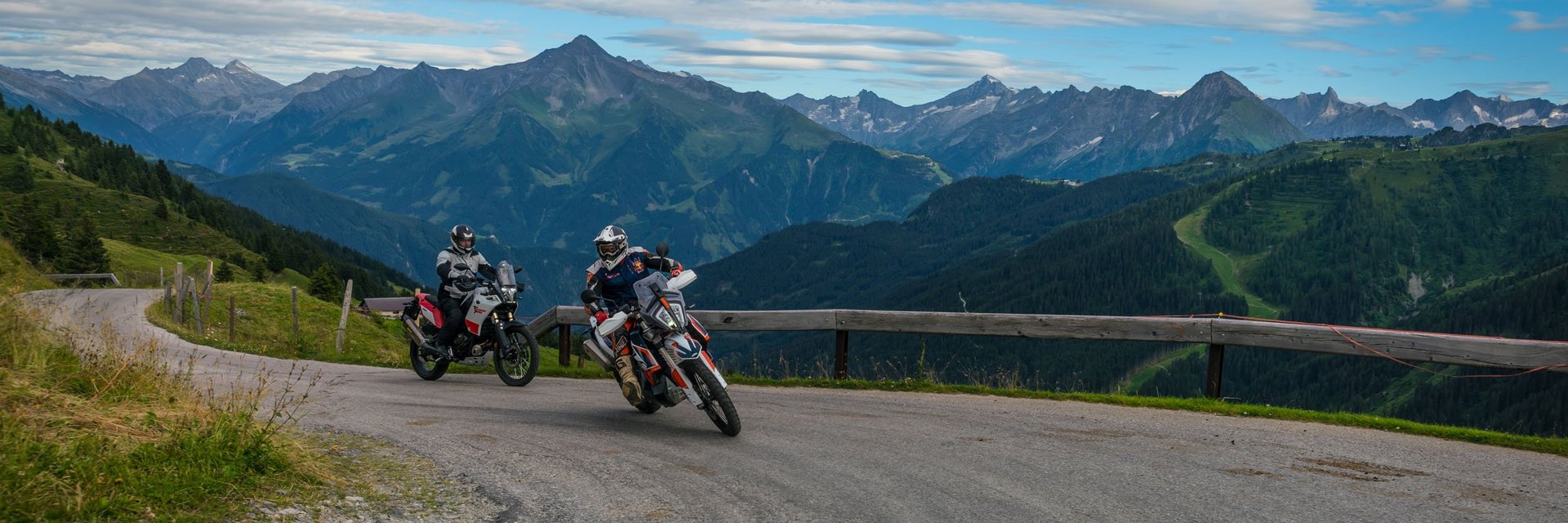 Hotel Sonnleiten *** Two motorcyclists riding on a mountain road with Alps in the background