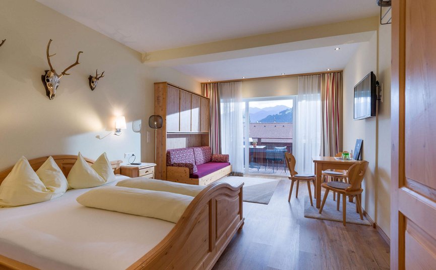 Hotel Sonnleiten *** Bright hotel room with wooden furniture and mountain view from balcony