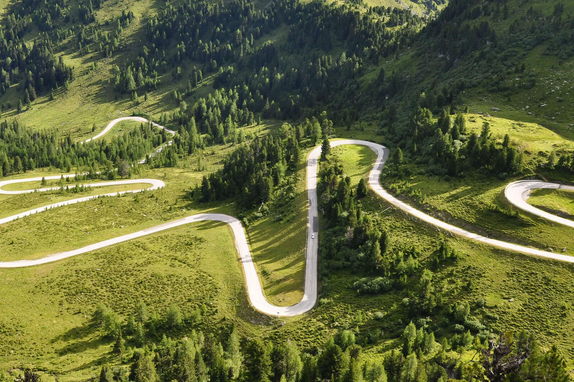 Motorbike holiday Winding mountain road through green hills and forest