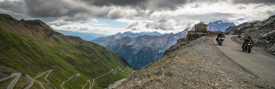 Moto Fun Anna *** © Moppetfoto.de Motorcyclists on winding mountain road under dramatic cloudy sky