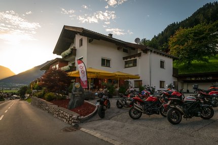 The Sonnleiten Ski and Motorcycle Hotel in Bruck in the Zillertal Valley © Moppetfoto.de Hotel with motorcycles parked at sunset in the mountains