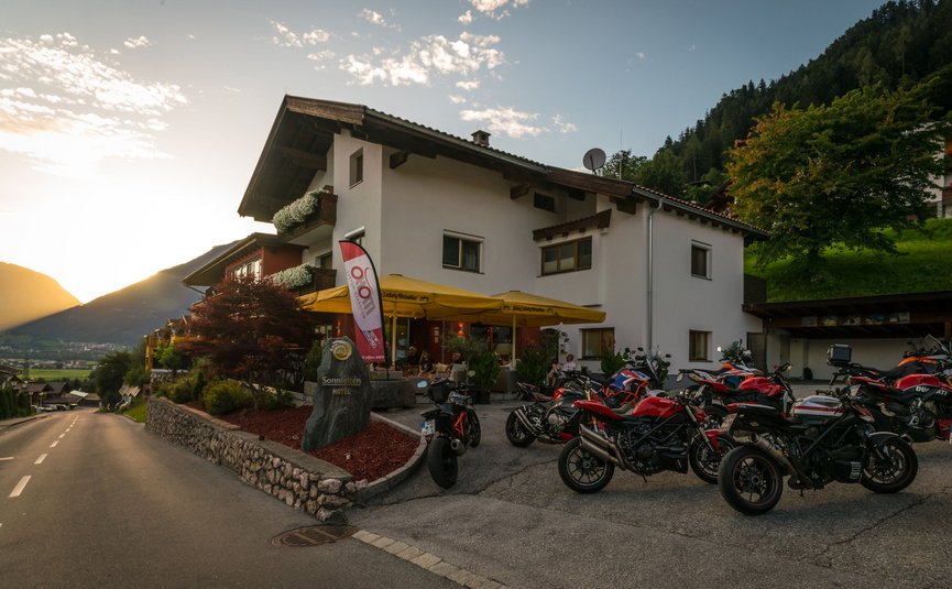 Hotel Sonnleiten *** © Moppetfoto.de Hotel with motorcycles parked at sunset in the mountains